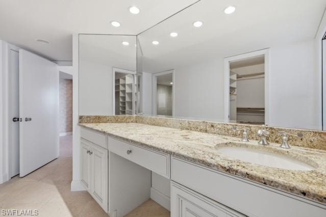 Double vanity with a granite countertop, integrated sink, and chrome fixtures