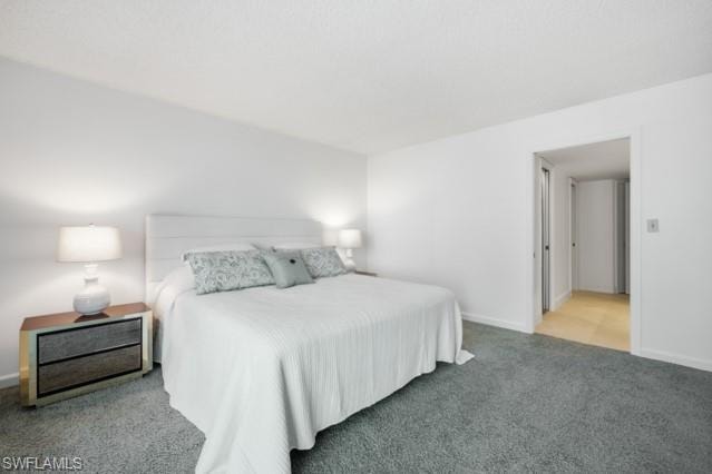 Bright bedroom featuring neutral white walls and a textured white headboard