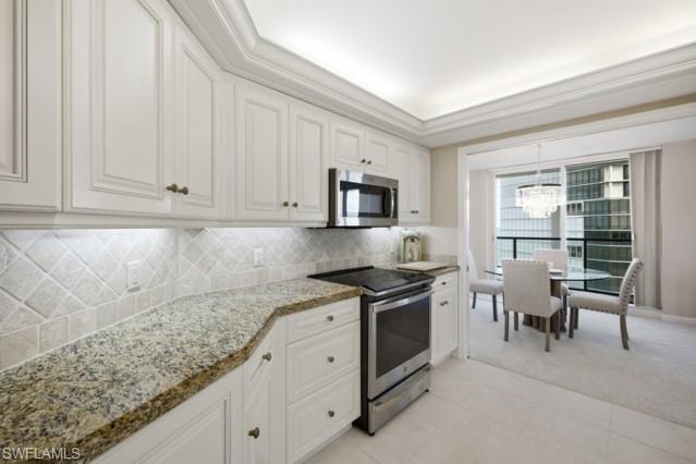Kitchen featuring white cabinetry, a tile backsplash, and granite countertops