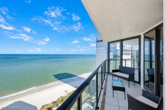 Private balcony with glass panel railing and tile flooring