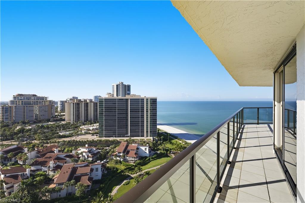 Expansive balcony featuring tile flooring and clear glass railings