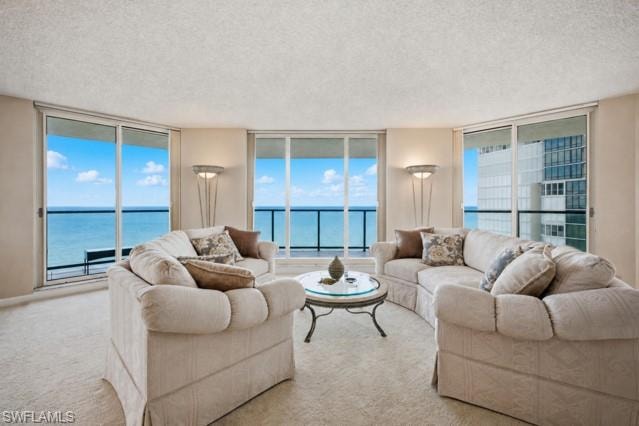Curved living space featuring expansive floor-to-ceiling sliding glass doors, direct water scenery, and a private balcony with glass railing