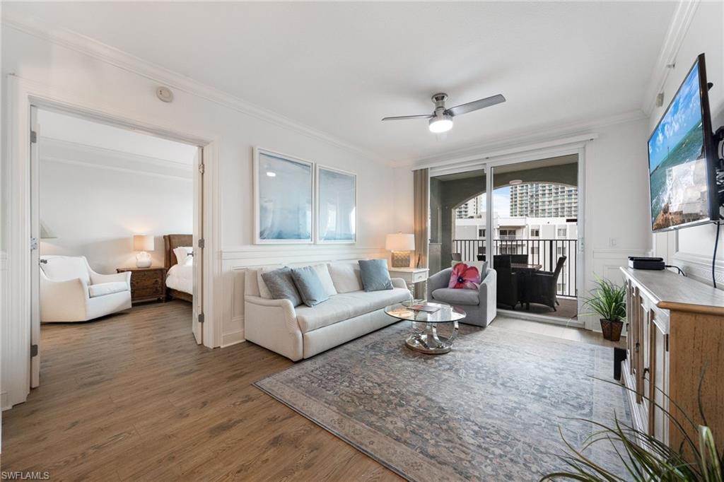 Living room featuring crown molding, ceiling fan, and dark hardwood / wood-style flooring