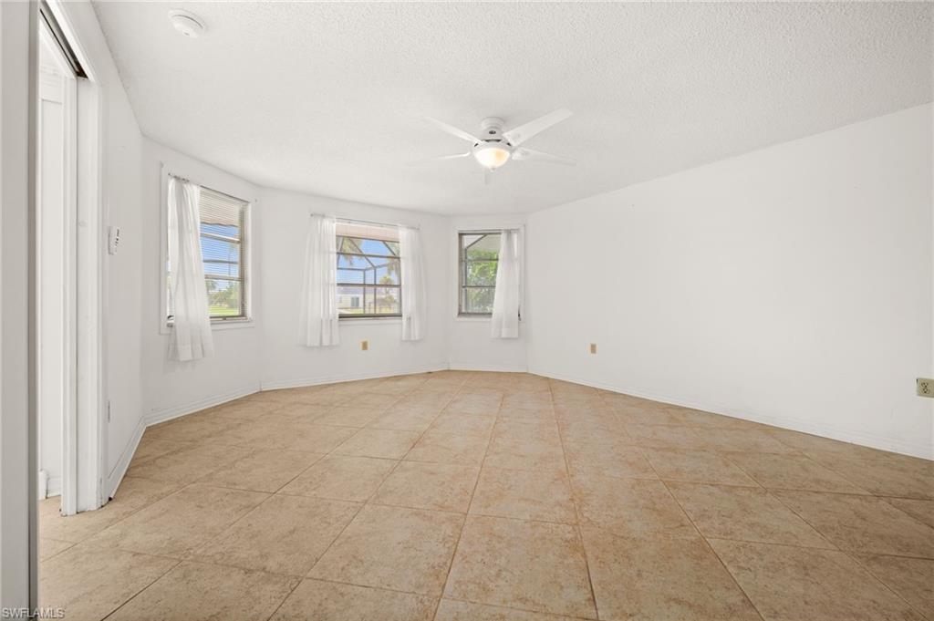 Primary bedroom with a walk in closet and view of the pool