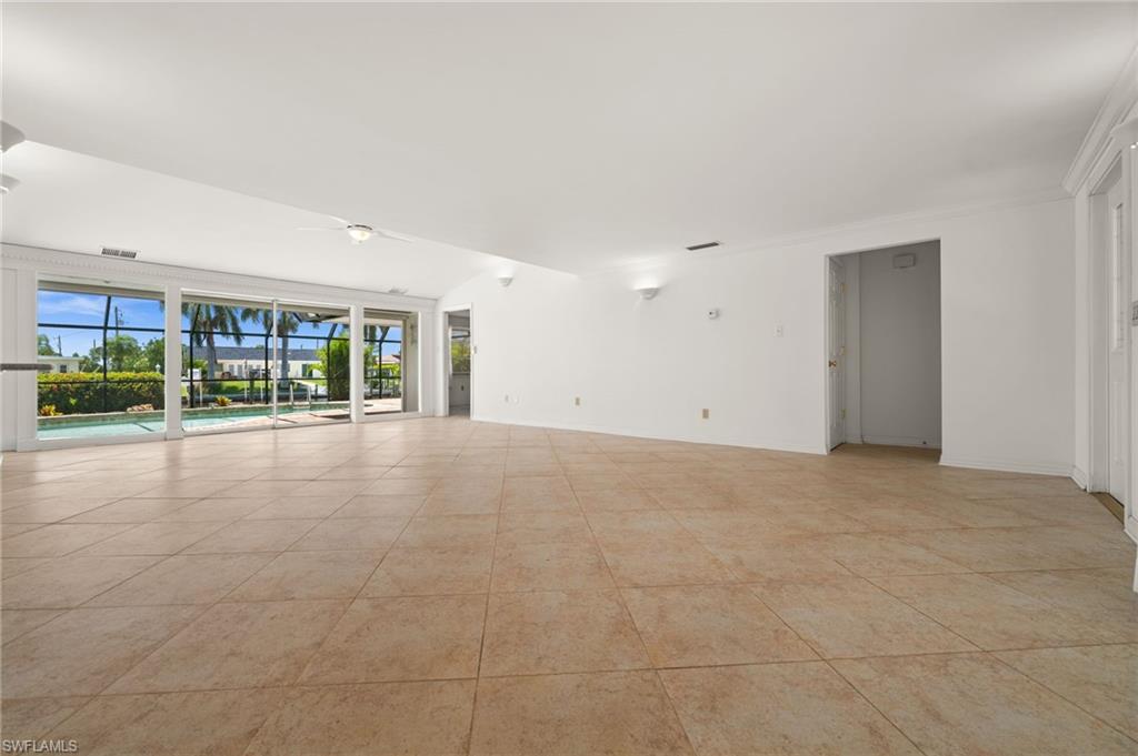 Looking from the front to the back of the living room, with a pool view