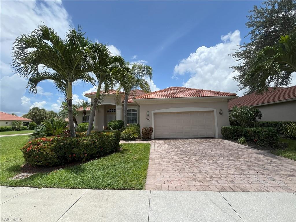 Single-story residence featuring a tile roof, stucco exterior, and a two-car garage