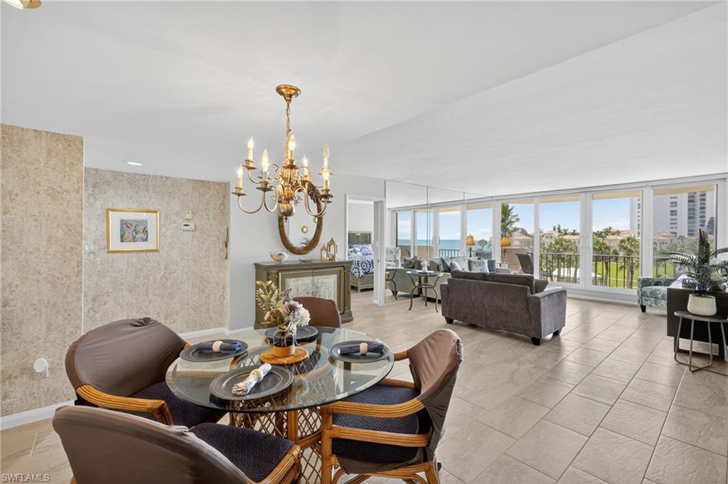 Dining area with a chandelier and floor to ceiling windows