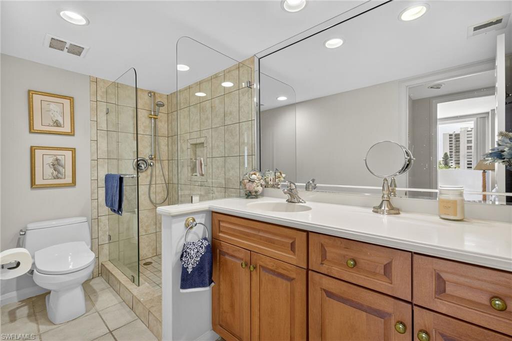 Guest Bathroom with tile patterned floors, vanity, a shower stall, and recessed lighting
