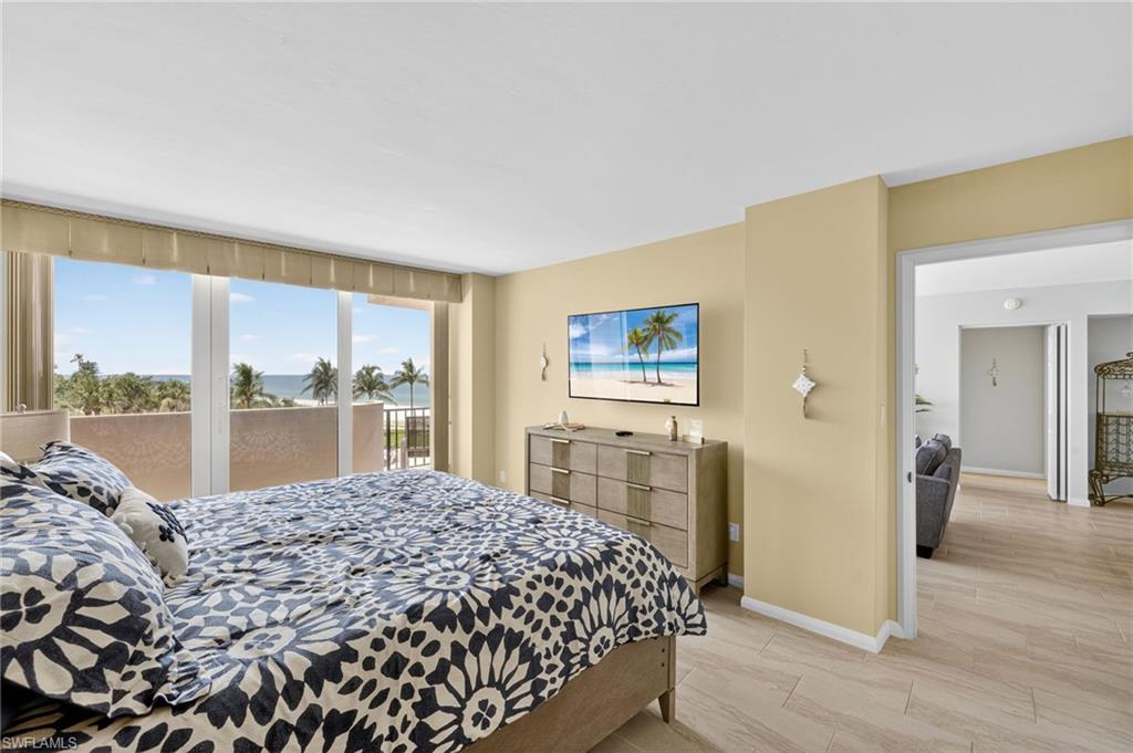 Bedroom with access to exterior and light wood-style flooring