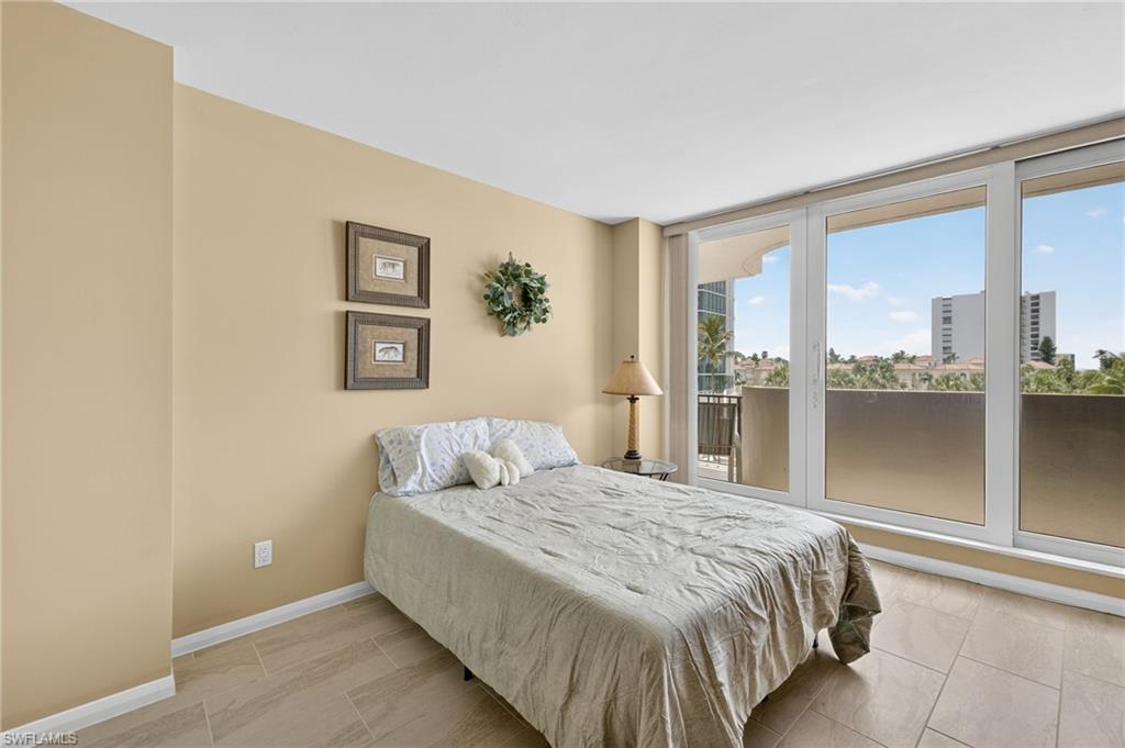 Bedroom with access to exterior and baseboards