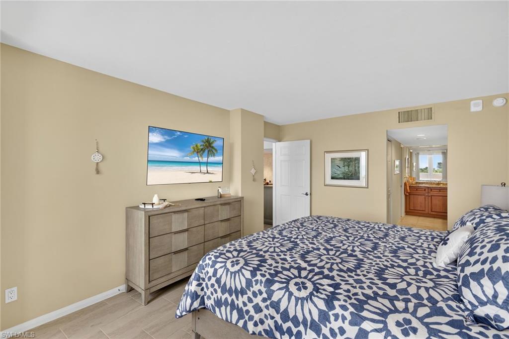 Bedroom with baseboards and ensuite bath