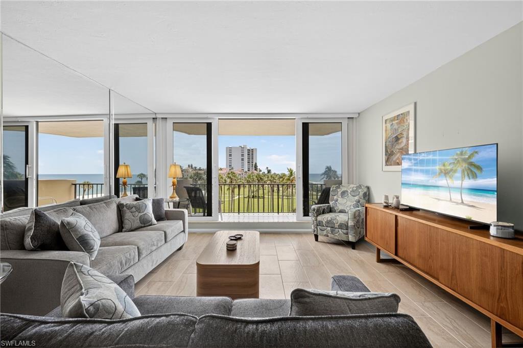 Living area featuring floor to ceiling windows and wood finish floors