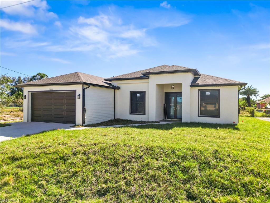 Contemporary single-story residence featuring a smooth stucco exterior and a dark shingle roof