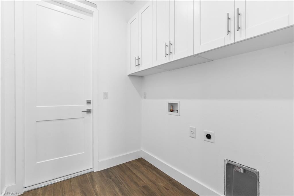 White cabinetry with brushed nickel pulls, wood-finish flooring, and white baseboards