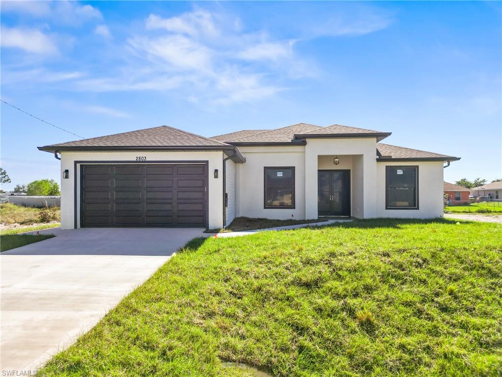Modern single-story residence with a light-colored stucco exterior