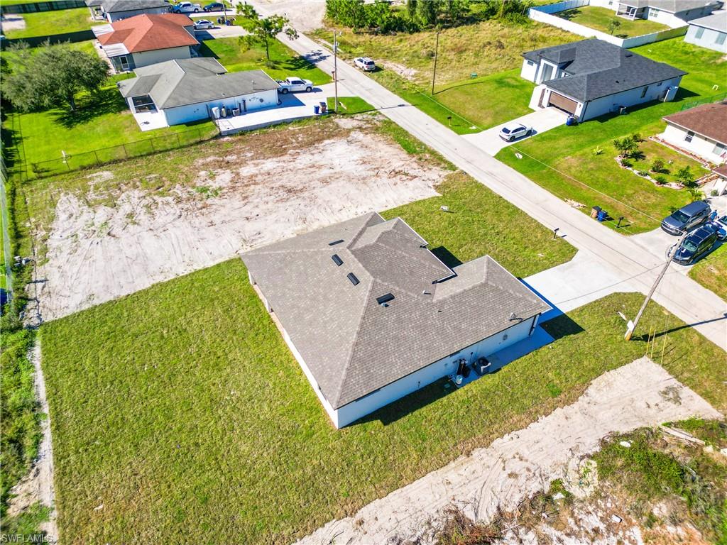 Newly constructed residence featuring a gray shingle roof and a light-toned exterior