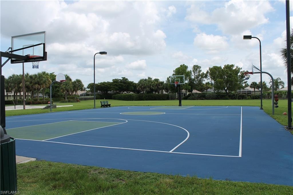 Full-size basketball court featuring a blue and green playing surface with white line markings