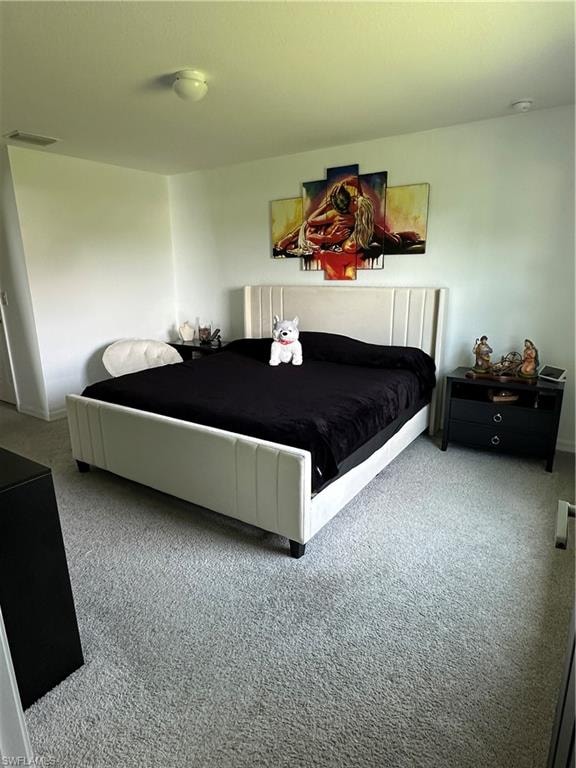 Spacious room featuring light-colored walls and plush carpet