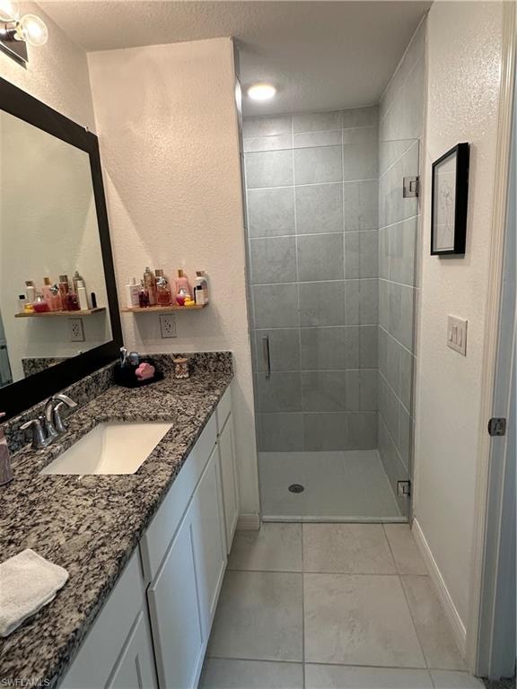 Bathroom featuring a single vanity with stone-finish countertop, undermount sink, and polished chrome faucet