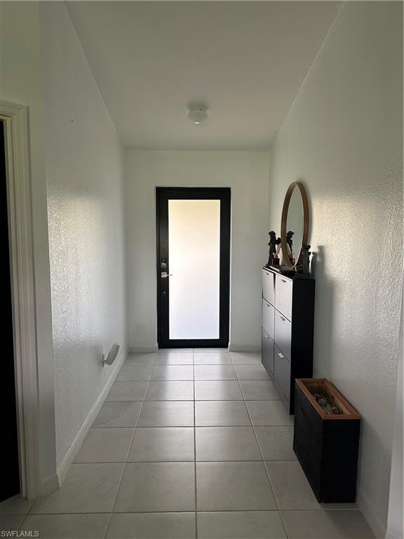 Entryway featuring light-toned tile flooring and white textured walls