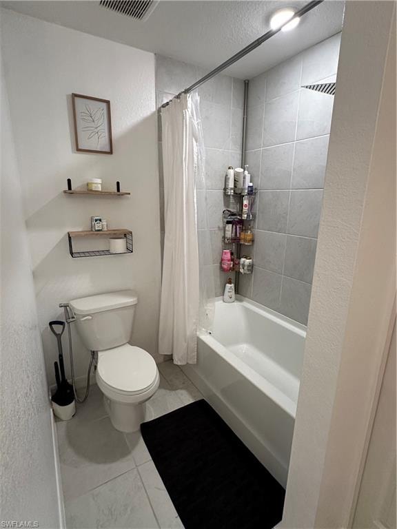 Bathroom featuring a white tub, shower with light gray tile surround, and a toilet