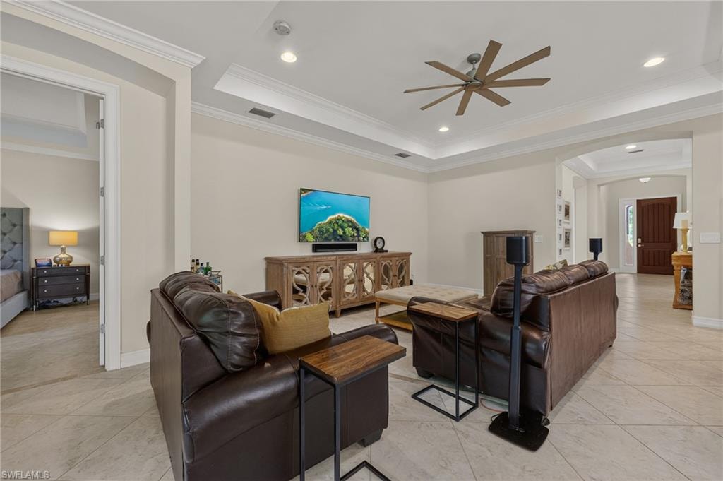 Spacious living area featuring neutral wall tones and large format tile flooring