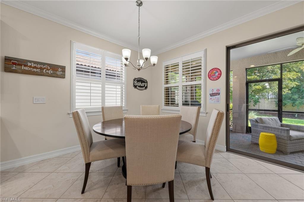 Dining area featuring tile flooring, crown molding, plantation shutters, and a chandelier lighting fixture