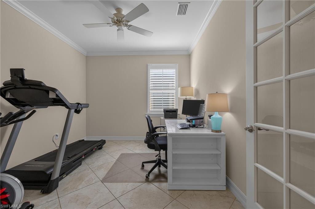 Versatile room featuring ceramic tile flooring, crown molding and French doors