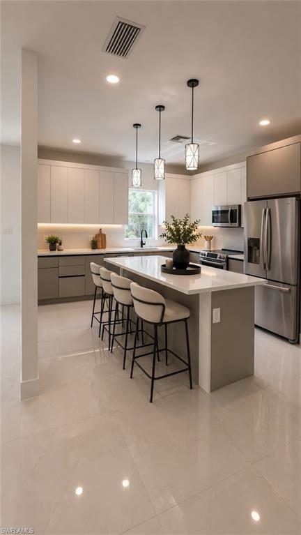 (AI Staged) Modern kitchen featuring a large central island with seating, stainless steel appliances, and sleek cabinetry