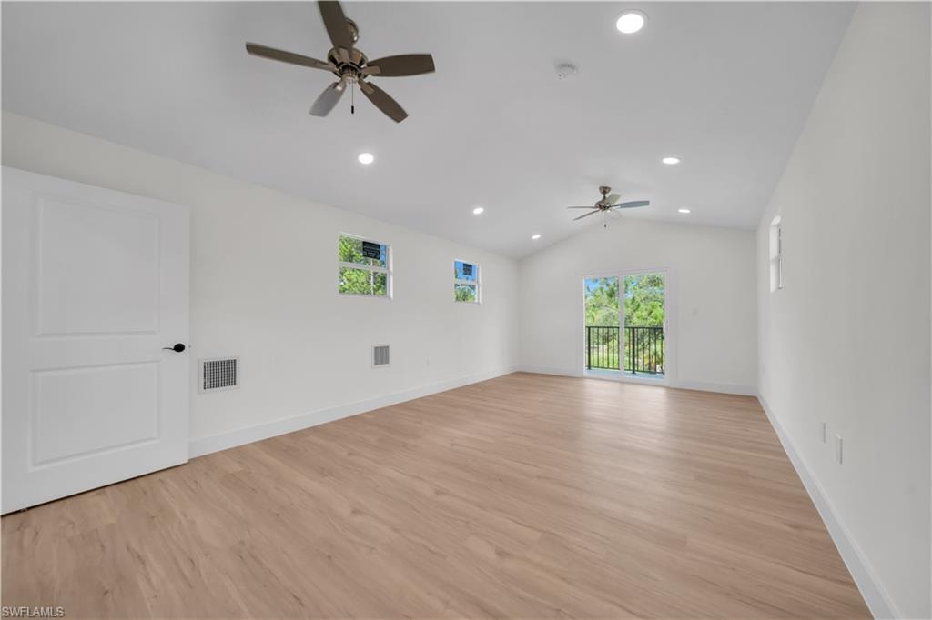 (Second Floor)Spacious flex room featuring vaulted ceilings, light wood-finish flooring, recessed lighting, and multiple windows