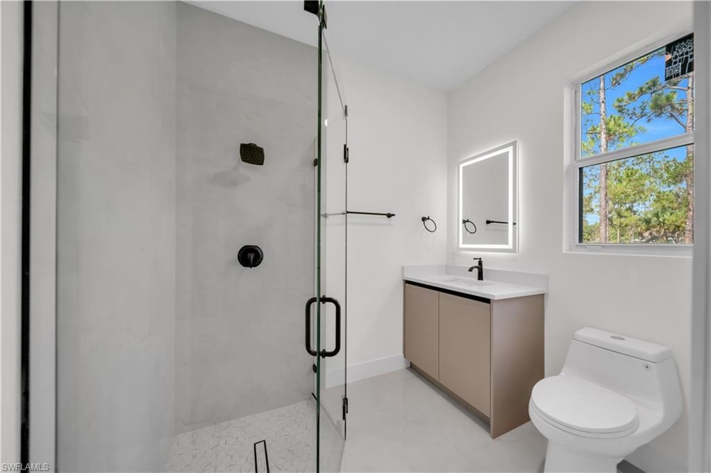 Contemporary third  bathroom featuring a glass-enclosed shower with matte black fixtures, a vanity with a white countertop and integrated sink, a backlit mirror, and a window providing natural illumination