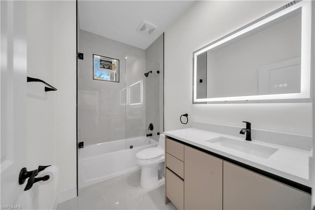 guest bathroom bathroom featuring a vanity with an integrated sink and light-colored countertop