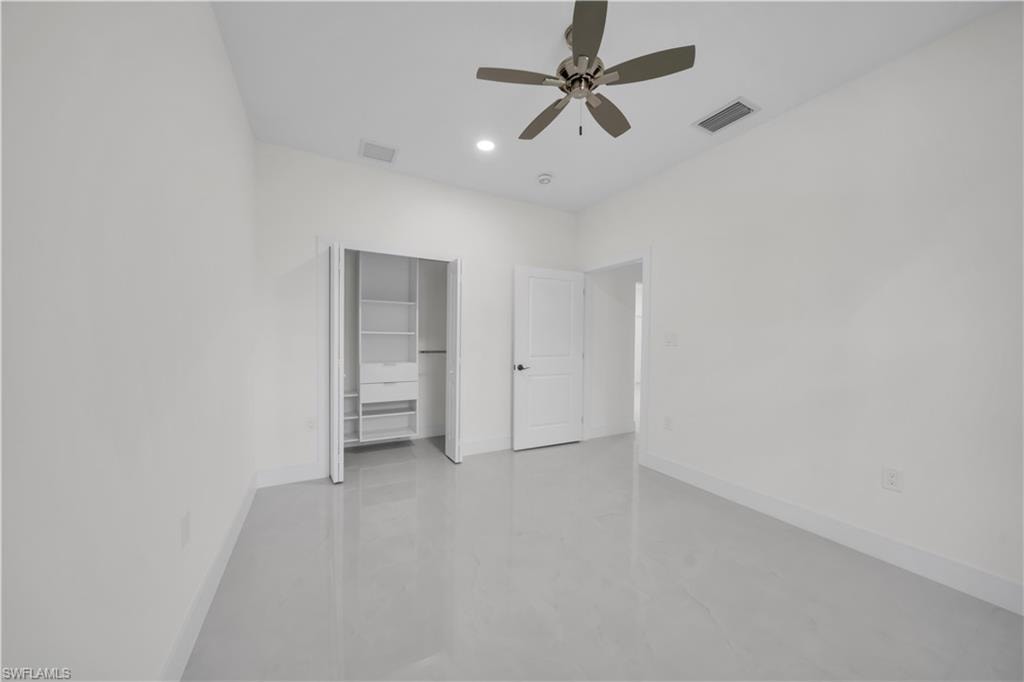 Bright interior space featuring light-toned flooring and white wall finishes