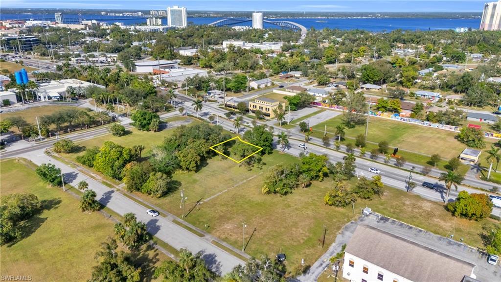 Aerial overview of property's location with a notable bridge, property boundaries highlighted, and a large body of water