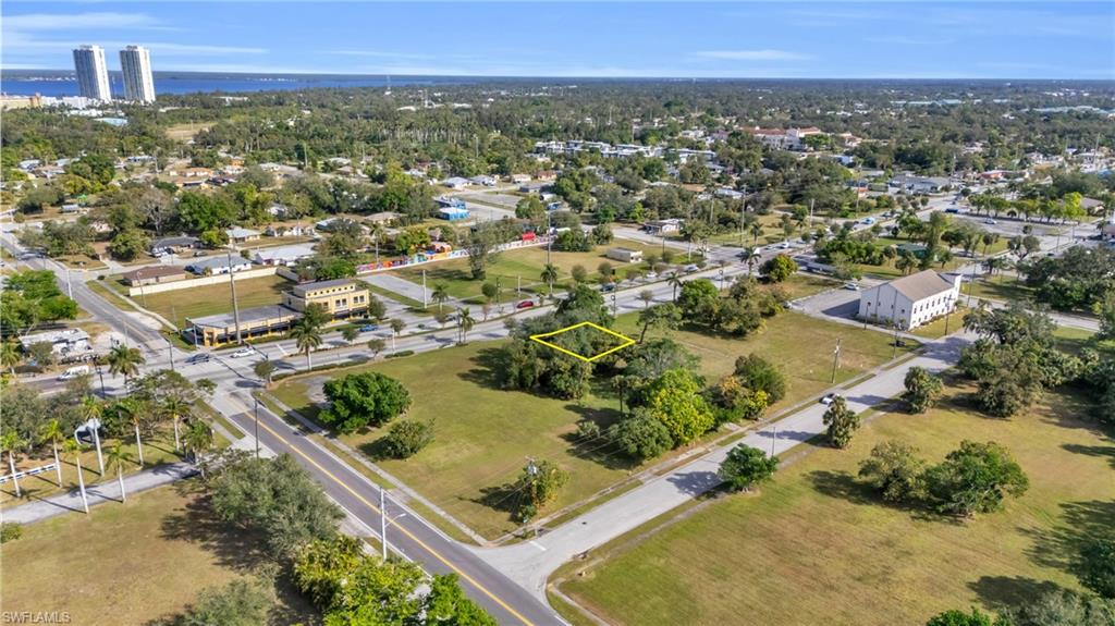 Aerial view of property and surrounding area featuring property parcel outlined