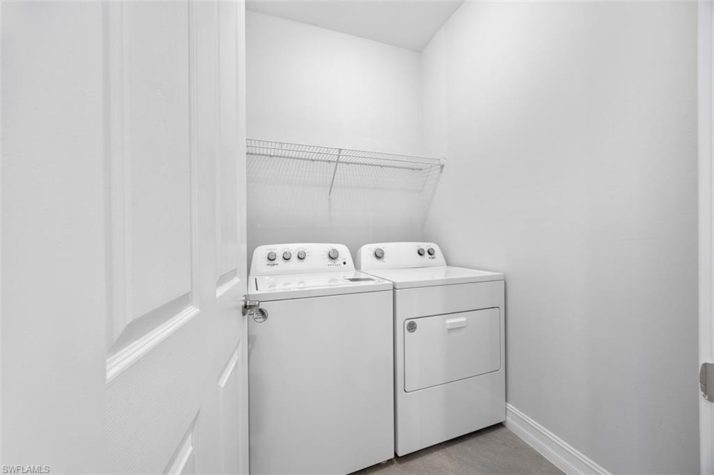 Laundry area featuring baseboards and washing machine and dryer