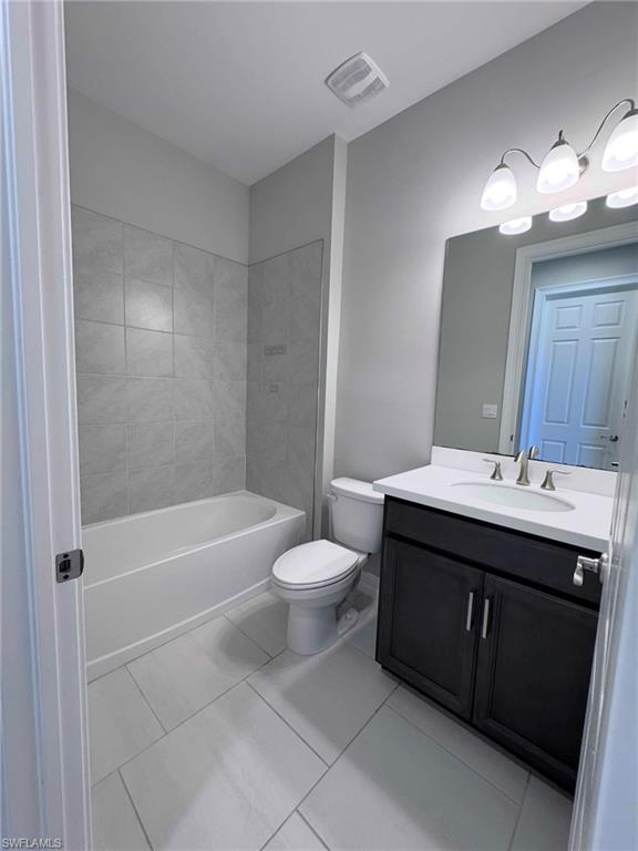 Full bathroom with vanity and light tile patterned floors