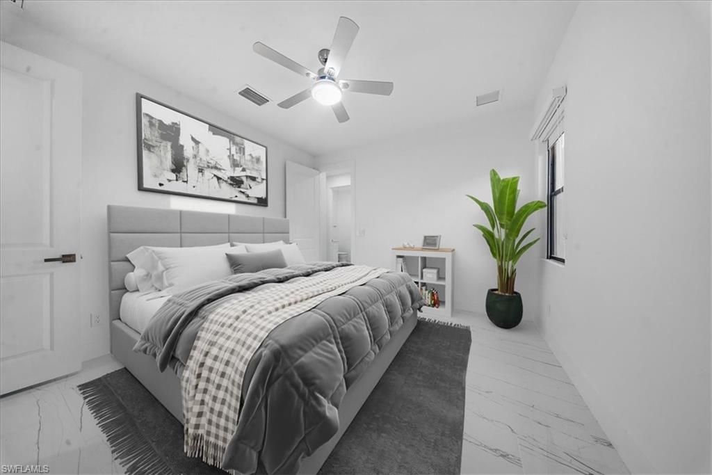 Bedroom featuring white walls and marble-look tile flooring