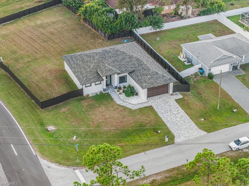 Single-story residence featuring a gray shingle roof and a two-car garage