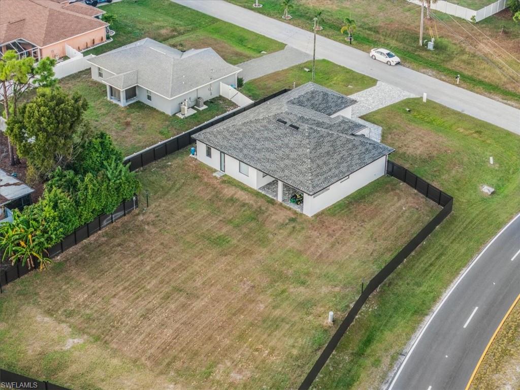 Contemporary single-story residence featuring a gray shingle roof and light-colored exterior siding