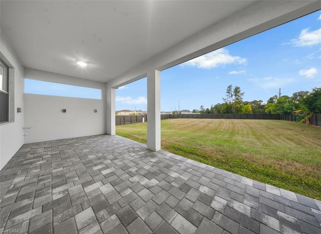Covered patio featuring a multi-tone paver floor, recessed lighting, and a transom window