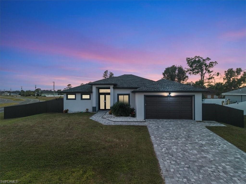 Beautiful 2023 home situated on an oversized double corner lot with paver driveway and modern curb appeal.