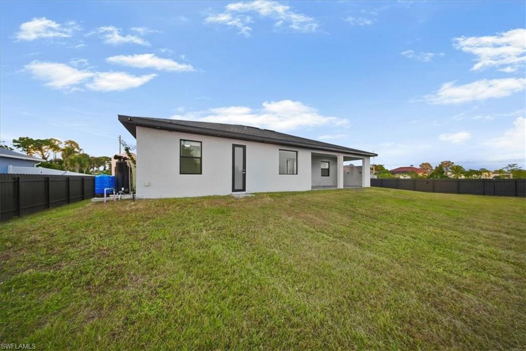 Expansive lawn with a black perimeter fence
