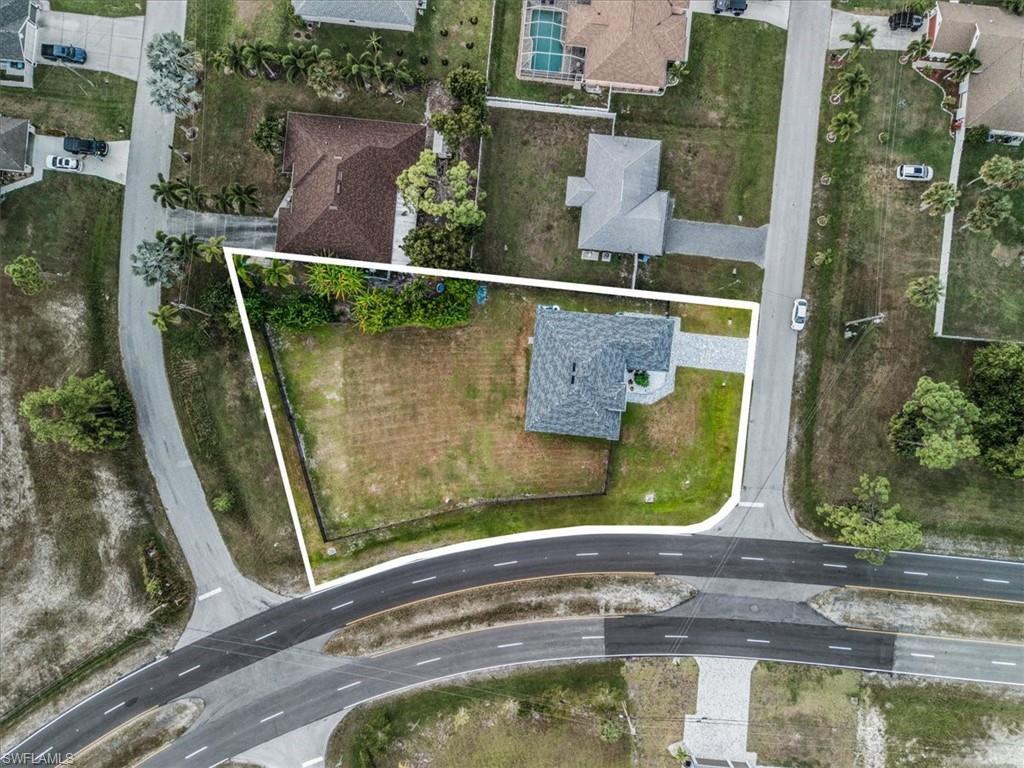 Single-story residence featuring a shingle roof and a paved driveway