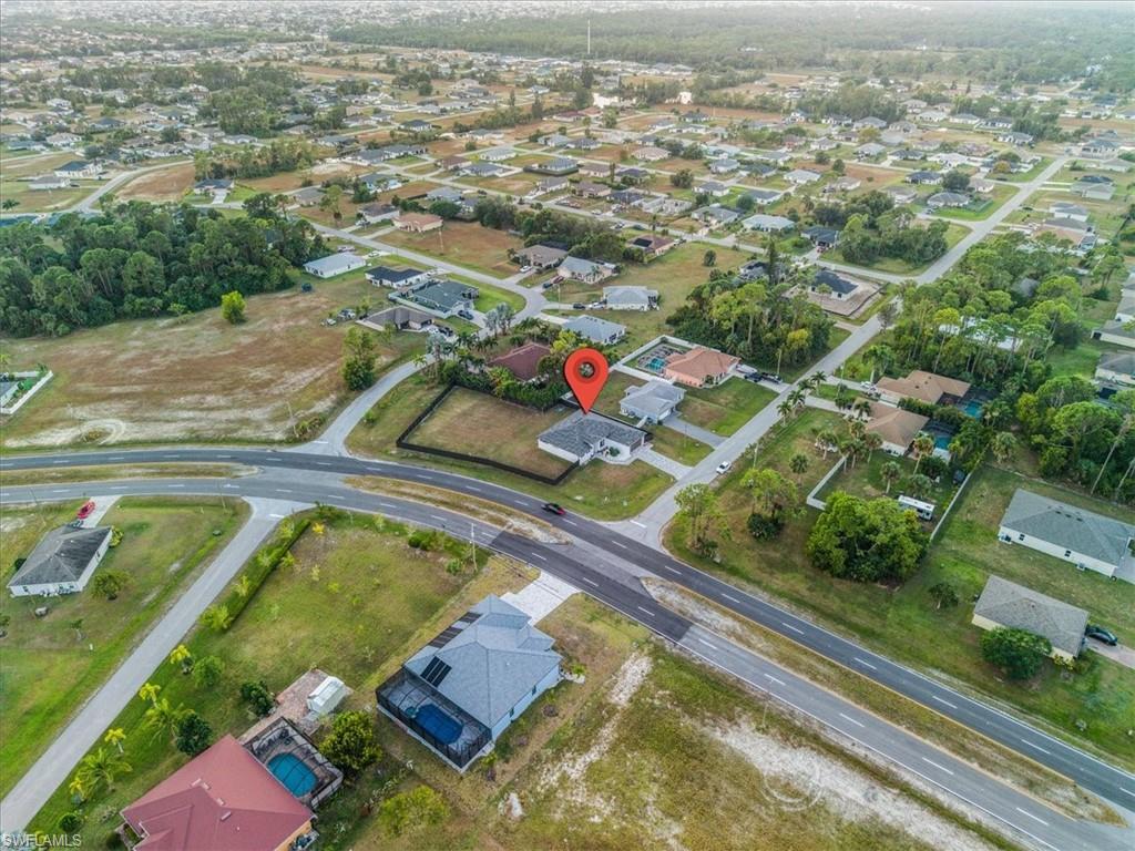 Aerial perspective showcasing a residential lot with a single-story home