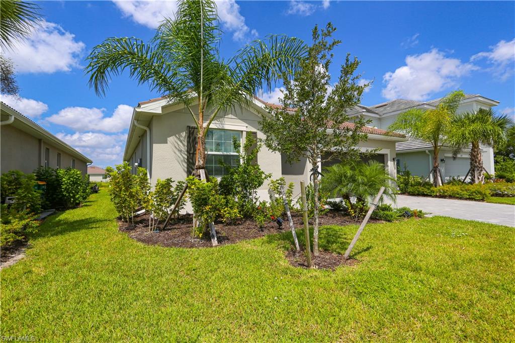 View of front of house featuring a front yard and a garage