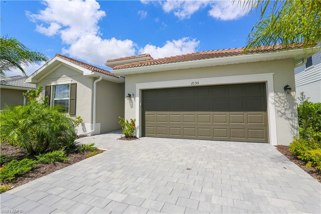 Mediterranean / spanish-style house with a garage