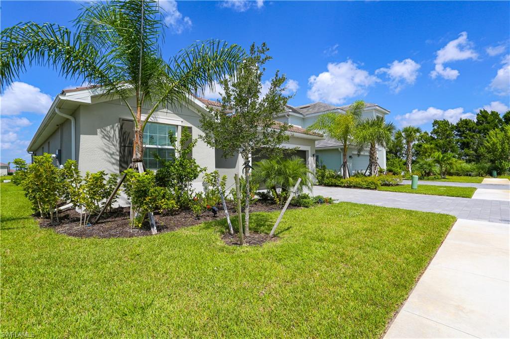 View of front of house with a front yard and a garage