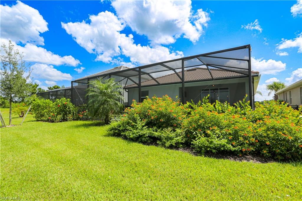 View of yard featuring glass enclosure