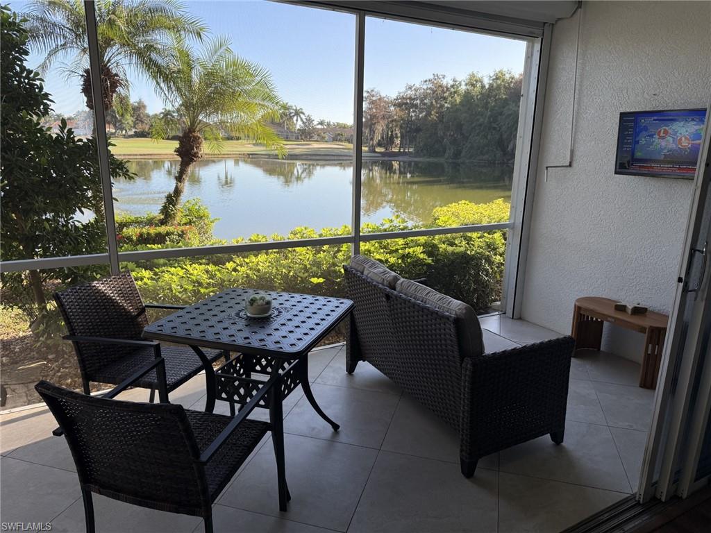Sunroom / solarium featuring a water view